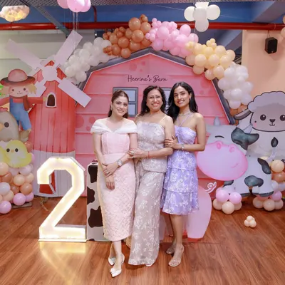 A full view of our "Barnyard Bash" setup. We use large-scale props like a barn facade, animal cutouts, and a light-up marquee number to completely transform the space and bring your theme to life.