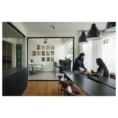 The heart of our studio is this large collaboration table. It's where we gather as a team to review plans, brainstorm ideas, and find that extra bit of magic for every project.