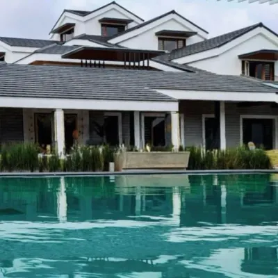 Reflections of sophistication. This large residence with classic influences is perfectly mirrored in the still water of the swimming pool, creating a stunning visual dialogue between the home and its landscape.