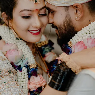 A tight, emotional close-up of a South Indian couple during their wedding ceremony, sharing a moment of pure joy. Capturing these candid, heartfelt interactions is a cornerstone of our documentary approach.