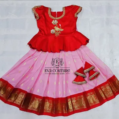 A ready-to-ship pattu pavadai for newborns to 1-year-olds. This red and pink set has a peplum top with bird embroidery and comes with extra margins to be used for up to 2.5 years.