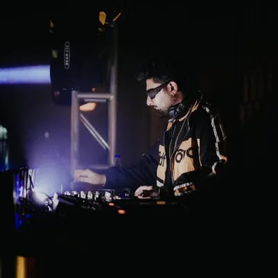 In the zone at Badmaash, surrounded by darkness and focused on the light of the console. This is where the magic happens.