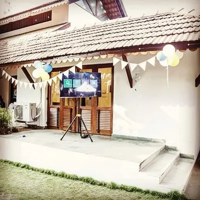 An LED TV set up on a tripod for an outdoor event. Renting a screen is an easy way to share memories through a photo slideshow, adding a personal and interactive element to any party.
