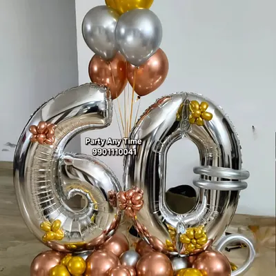 A beautiful 60th birthday bouquet with large silver foil numbers and rose gold, silver, and gold chrome balloons.