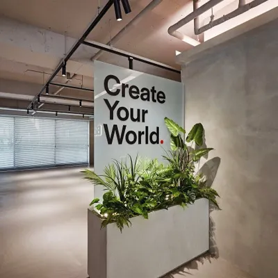 A great example of biophilic design in a commercial space. This large concrete planter acts as a natural divider and a green focal point, bringing life and fresh air into a modern office lobby.