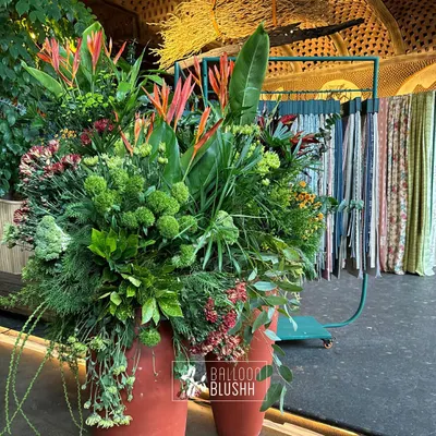 We created this lush, tropical arrangement featuring birds of paradise and rich greenery for a home decor brand's event. This style of floral design is perfect for adding a touch of exotic elegance to any space.