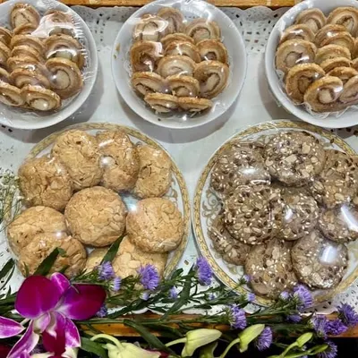 A beautiful dessert platter prepared for a special occasion. This tray features an assortment of our freshly baked French hearts, almond cookies, and date seed cookies, all packed and ready to delight your guests.
