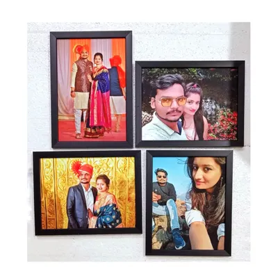 A set of four matching black wall frames, each containing a different photo, creates a beautiful gallery wall. This set was made for a housewarming occasion.