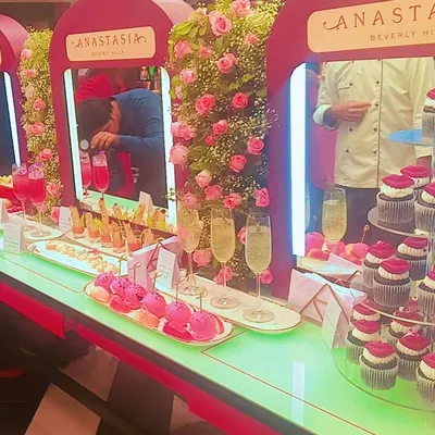 A whimsical dessert bar we created for Anastasia Beverly Hills. The display includes custom cupcakes with lipstick toppers, pink macarons, and sparkling beverages to match the brand's glamorous aesthetic.