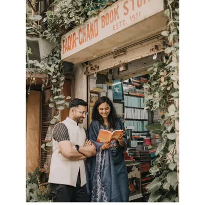 A sweet moment shared over a book at the iconic Faqir Chand Book Store. This is a perfect example of a personalized urban pre-wedding shoot that reflects a couple's shared interests.