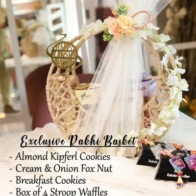 My most luxurious Rakhi offering, the Exclusive Rakhi Basket. This crescent-shaped jute basket is packed with Almond Kipferl Cookies, Cream & Onion Fox Nuts, Stroop Waffles, Hazelnut Biscotti, and a beautiful Resin Rakhi.