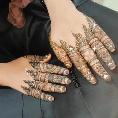 A beautiful example of detailed finger mehendi. Each finger has a unique, intricate pattern, creating a stunning look that is both elegant and eye-catching.
