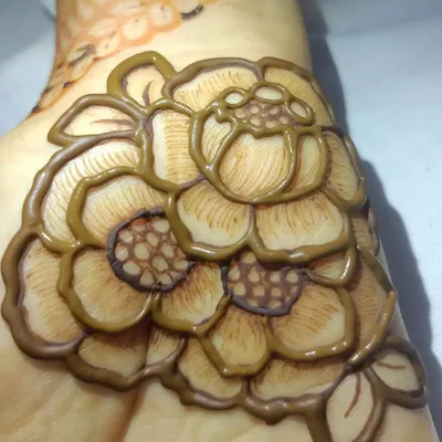 A close-up of a 3D floral element. I create this effect by carefully layering the henna paste, which adds texture and depth to the design.