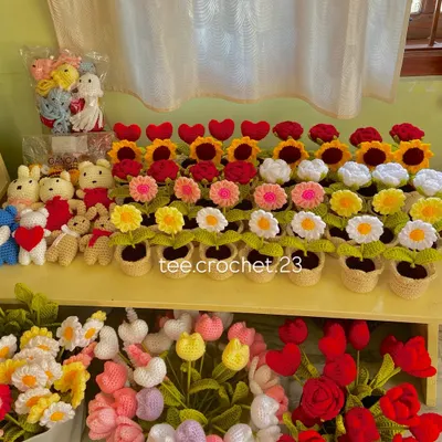 A beautiful display of my handmade crochet flowers and accessories. This shelf includes potted flowers, bouquets, and bunny keychains from a recent large order.