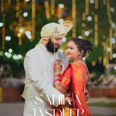 A beautiful evening portrait of a Maharashtrian couple, with the warm glow of decorative lights creating a magical bokeh effect. We excel at using ambient light to create romantic wedding photos.