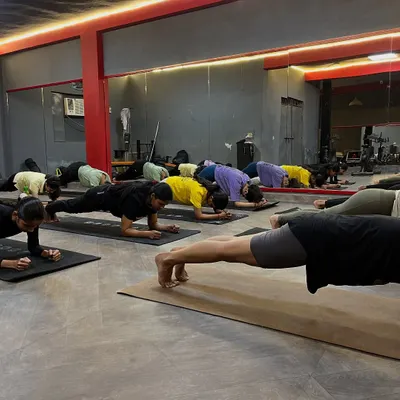 The power of practicing together. The entire class holds Phalakasana (Plank Pose), building core strength and endurance as a group.