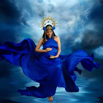 A portrait of pure power and grace. The deep blue gown flows like water, and the celestial crown adds a touch of divine energy, creating a truly breathtaking image of motherhood.