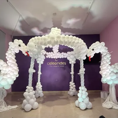 An intricate swan mandap made entirely of white balloons. This is an example of an advanced balloon sculpture project our students learn to create during their practical exam sessions.