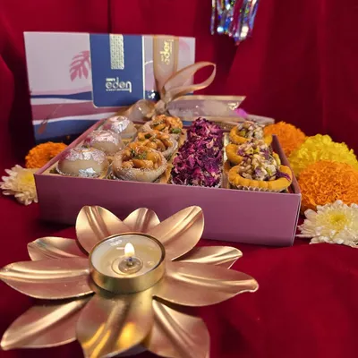 Embrace the blessings of the festive season with a box of my handcrafted sweets. This assortment, featuring rose petal and nut-topped mithai, is perfect for Laxmi Puja and Diwali celebrations.