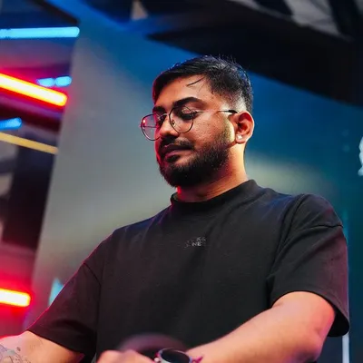 Lost in the music during a live set. This is me in my zone, completely focused on the rhythm and the energy of the room. Every performance is a journey, and I love guiding the crowd through it.