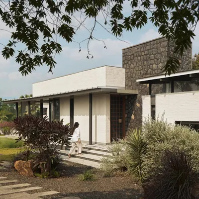 Introducing Pavilion House, set on a grassy expanse overlooking the backwaters of Lake Beze in Nashik. Inspired by prairie-style homes, its steel and glass composition is designed to establish a profound connection with the landscape, creating a true escape from the city.
