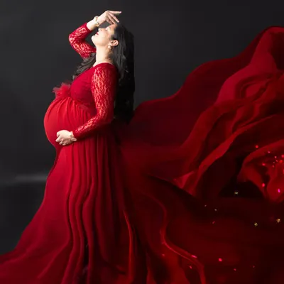 A truly powerful and dramatic portrait. The way the red fabric of the gown flows looks like liquid fire, creating an unforgettable image of strength and beauty.