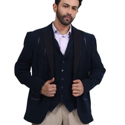 A male model in a sharp navy blue three-piece suit, shot against a clean white background for a classic e-commerce catalogue look.