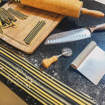The tools of the trade for my Agnolotti Tigre. From the laminated charcoal dough to the rolling pin and pasta wheel, everything is prepared for crafting these pasta pillows by hand.