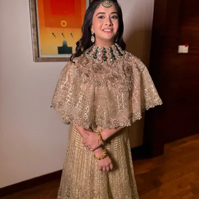 The sister of the groom looking like a whispering beauty. I gave her a soft glam look with subtle, glowing makeup that perfectly complements her Indo-Western cape-style outfit.