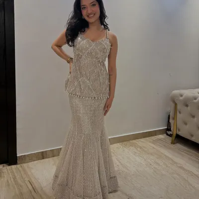 A client looking like a dream in our beaded peplum top and skirt set. This Indo-Western silhouette is perfect for a sangeet or cocktail party, offering glamour and comfort.