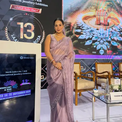 Poised and ready by the stage at the International Jewellery & Gem Exhibition, a premier B2B event.