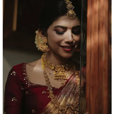 A timeless bridal portrait. We use soft, dramatic lighting to highlight the intricate details of the bride's temple jewellery and the serene expression on her face.
