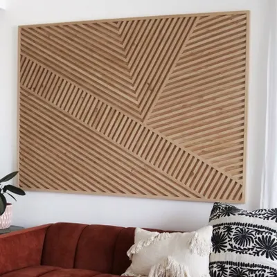 A large abstract wood art panel creating a stunning feature wall. The intersecting diagonal lines add a dynamic sense of movement, while the natural wood finish brings warmth to the modern design.