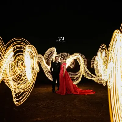 We created magic with light painting in this dramatic night shoot. The golden swirls of light wrap around the couple, creating a stunning visual effect that is both energetic and romantic.