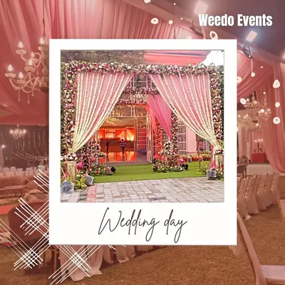 A magnificent entrance for a day wedding, framed like a polaroid. The grand structure is draped in pink fabric with heavy floral borders, creating a picture-perfect welcome.