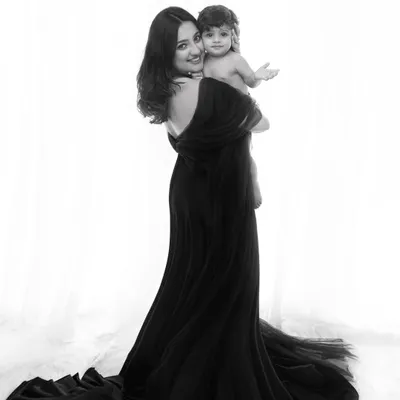 A timeless black and white portrait celebrating the bond between a mother and her child. The dramatic silhouette and elegant styling create a piece of fine art for your family.
