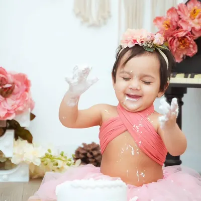 The pure joy of a first birthday cake smash. This little one is having the best time, and we're here to capture every messy, happy moment.