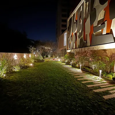 For the "FRAMED AUSTERITY" project, we used subtle uplighting on plants and a gentle wash of light on the pathway to guide movement and create a serene mood.