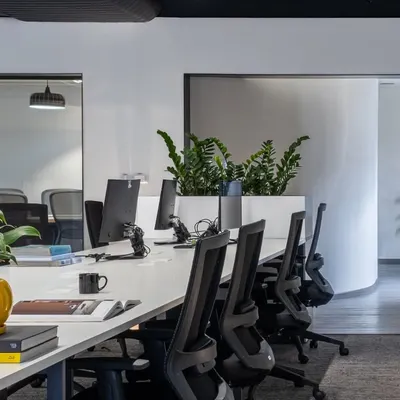 An open-plan office designed for collaboration and energy. I use long, shared desks and integrated planters to create a dynamic environment that encourages interaction while maintaining a clean aesthetic.