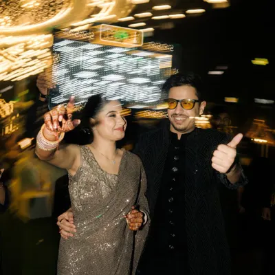 A fun, high-energy shot of the couple on the dance floor, captured with a slow-shutter effect to convey motion and excitement. This is perfect for capturing the party vibe.