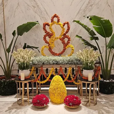 This elegant Ganesh installation was created for the lobby of the Fairmont hotel in Mumbai. I used yellow and orange marigolds to craft the central figure, complemented by white tuberoses and large tropical plants for a balanced and respectful display.
