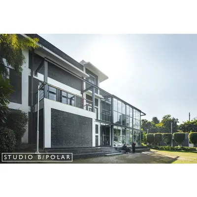 The exterior of the Media Monks campus in Noida, a 100,000 sq. ft. project we completed in 12 months. Our design refreshed the existing buildings and emphasized a seamless connection to the central lawn and surrounding landscape.
