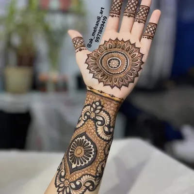 A beautiful and clean design featuring a central mandala on the palm, extending into a patterned cuff. This is a great option for someone who wants a traditional look that isn't full coverage.