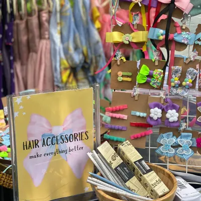 You'll find the most charming accessories at my events, like this adorable display of hair bows and clips. It’s the little details that make an outfit special, and I curate vendors who excel at them.
