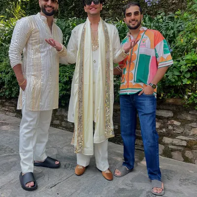 YouTuber Nischay Malhan celebrating in our custom off-white kurta set. The outfit features a long kurta with a matching stole, both adorned with beautiful mirror work.