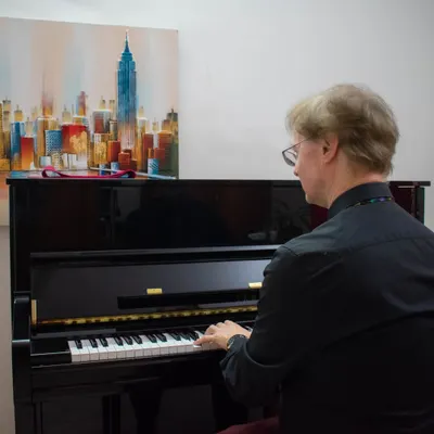 Mr. Richard Lewis, an esteemed examiner from ABRSM, playing the piano during an examination session held at our BEML branch.