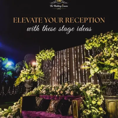To elevate a reception, I combine dramatic florals with unique lighting. This stage features a lush arrangement of white and green flowers cascading over a plush velvet sofa, with a backdrop of sparkling light strings for a truly glamorous effect.