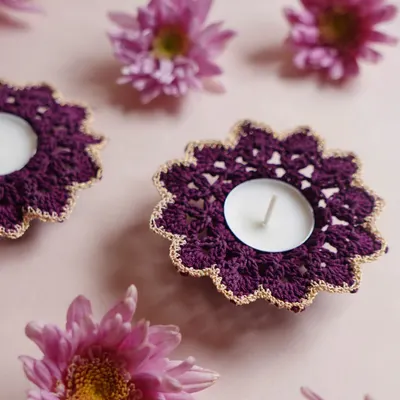 Our elegant purple crochet diya coasters with a delicate gold trim. These are designed to hold standard tea lights and add a touch of handmade luxury to your Diwali decor.