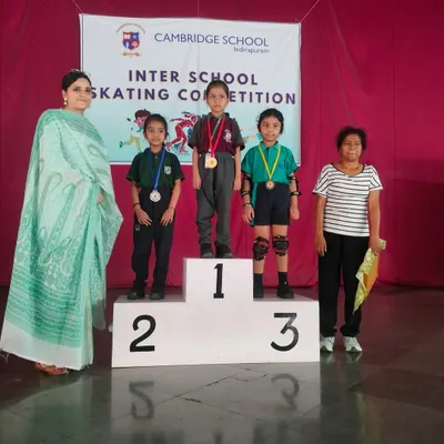 A glorious achievement! Our budding athlete stands proudly on the winner's podium after securing a medal at the Inter-School Skating Competition.