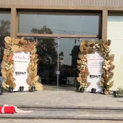 The grand entrance for a real estate project inauguration, featuring elegant boho-style arches with dried florals that create a sophisticated and welcoming first impression.